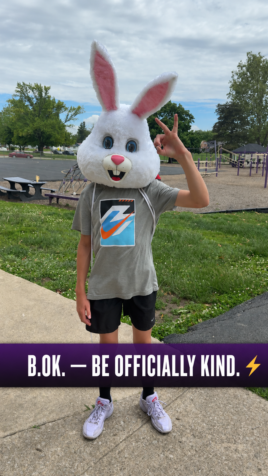 Student showing the B.O.K. — Be Officially Kind hand signal