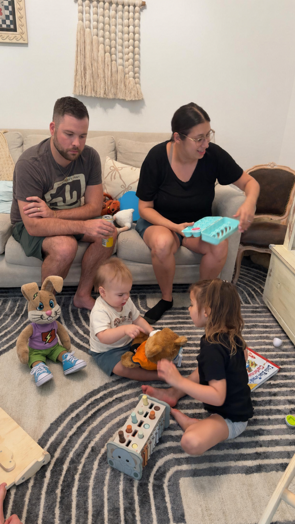 Carter on the floor with OG Bunny, family gathered in the living room